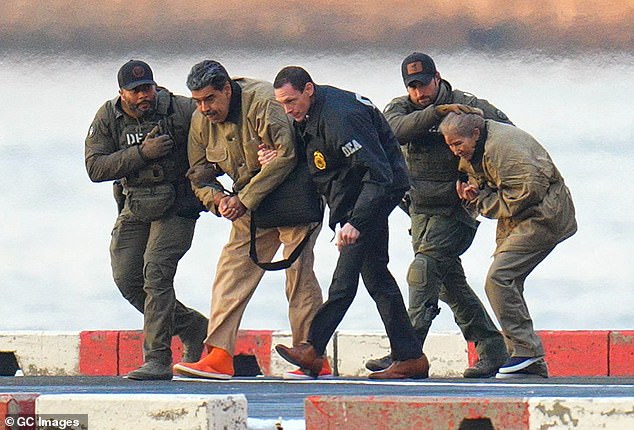 Nicolas Maduro and his wife Cilia Flores are seen arriving on a helipad in Manhattan in handcuffs for an arraignment in the Souther District of New York on January 5, 2026