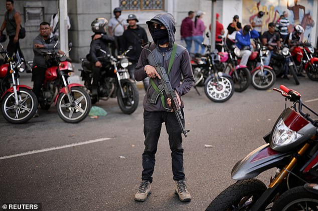 Plain-clothed gunmen were seen patrolling the streets of the capital, Caracas, calling for the release of Venezuela's President Nicolas Maduro