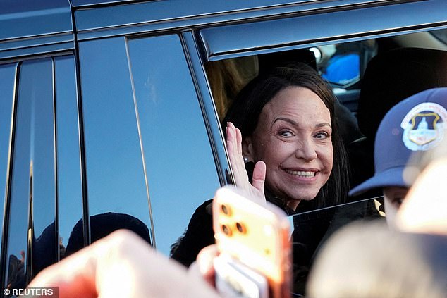 Maria Corina Machado waves from her vehicle Thursday as she departs Capitol Hill following an earlier meeting at the White House with President Donald Trump