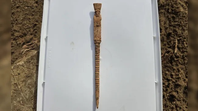 An ancient bone stylus depicting Dionysus with an erect phallus, discovered in southern Sicily.