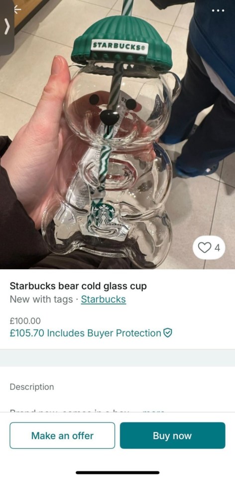 A Starbucks bear cold glass cup with a green beanie lid and a striped straw, offered for sale on an e-commerce site.