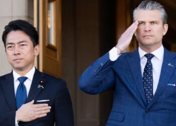 Defense Secretary Pete Hegseth and Japanese Defense Minister Shinjiro Koizumi, left, stand for the national anthems Thursday as Koizumi arrives for meetings at the Pentagon in Washington, D.C.