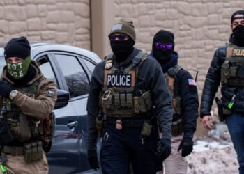 Immigration and Customs Enforcement agents walk near vehicles in Richfield, Minnesota, on Jan. 15, 2026.