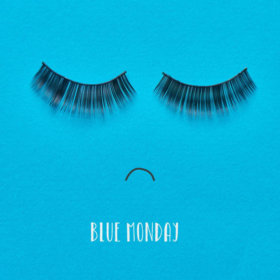 the text blue monday and a pair of fake eyelashes and a mouth drawn on a blue background forming a sad face