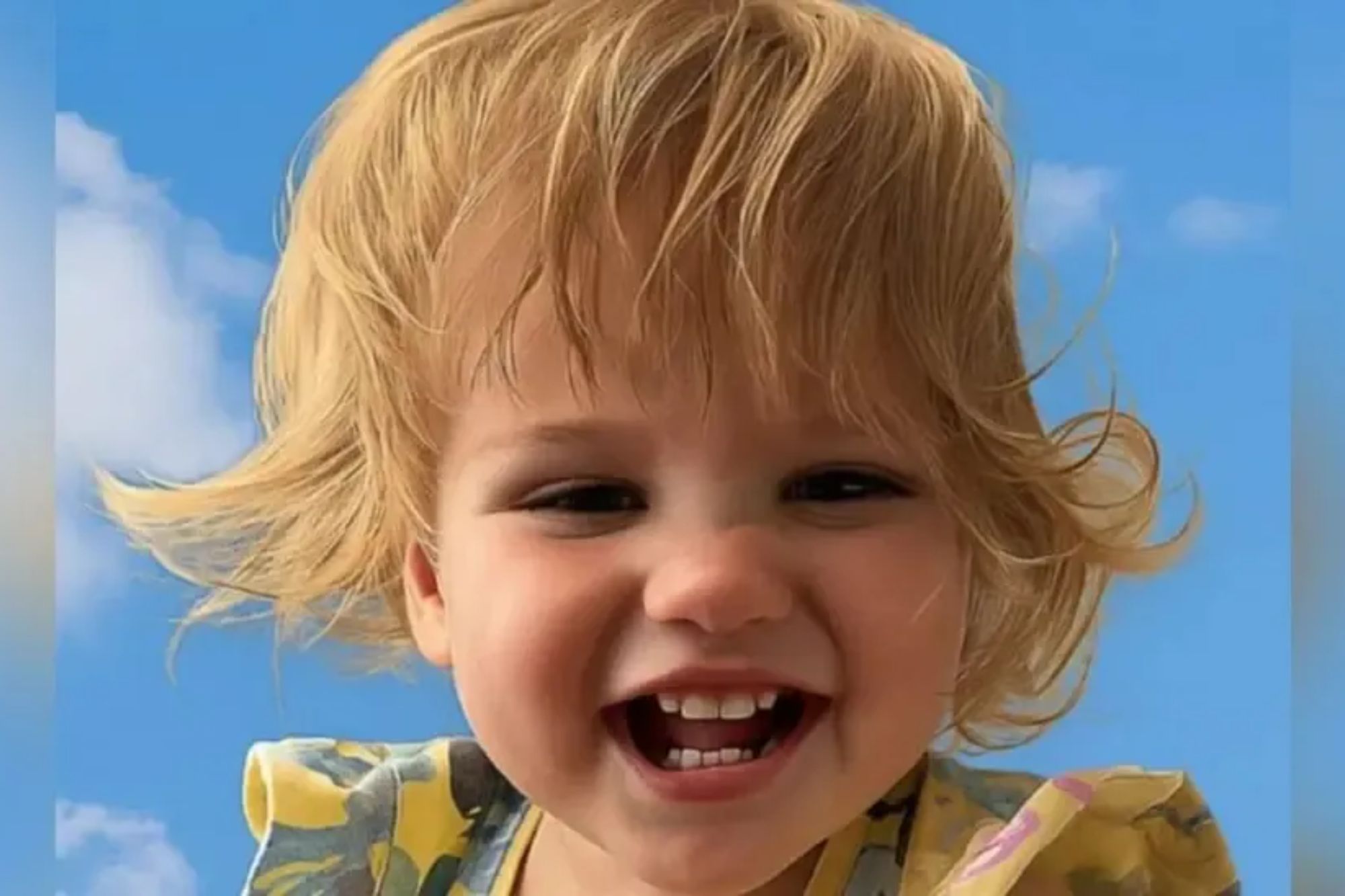 An image collage containing 1 images, Image 1 shows A smiling toddler with blonde hair against a blue sky with clouds