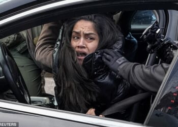 The video shows the unidentified woman being pulled from her car as she desperately clung onto the driver's side door on Tuesday