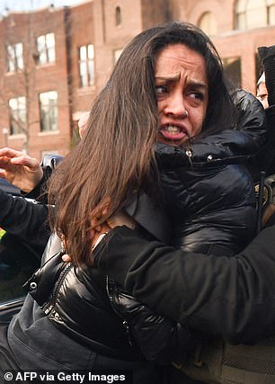 Other protesters around her also heckled the agents as they carried out the operation