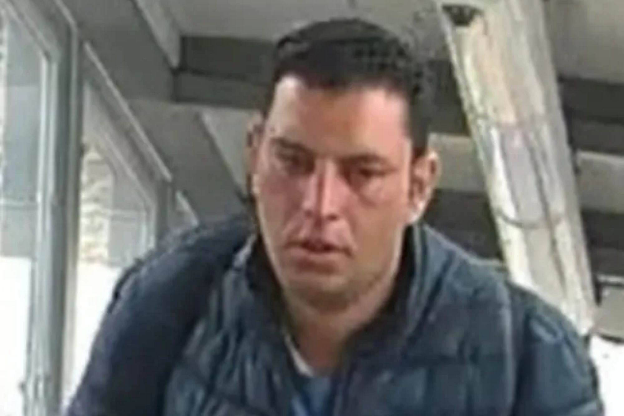 An image collage containing 1 images, Image 1 shows A man with dark hair in a dark blue puffer jacket holding a white tissue in his right hand