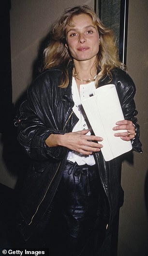 Maryam d'Abo wearing a black leather jacket over a white shirt  in 1992