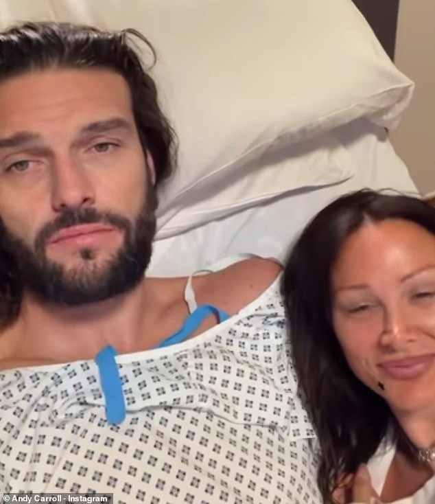 Andy was dressed in a gown and attached to a drip as he wrapped his arm around the hairstylist and planted a kiss on her nose