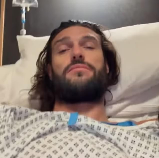 The footballer, 37, took to the platform fresh from the operating theatre while cosying up to girlfriend Lou Teasdale, 42, in his hospital bed.