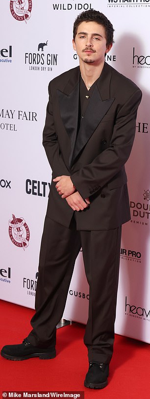 Timothee Chalamet also attended the event as he kept it simple in a dark brown suit with black lapels.