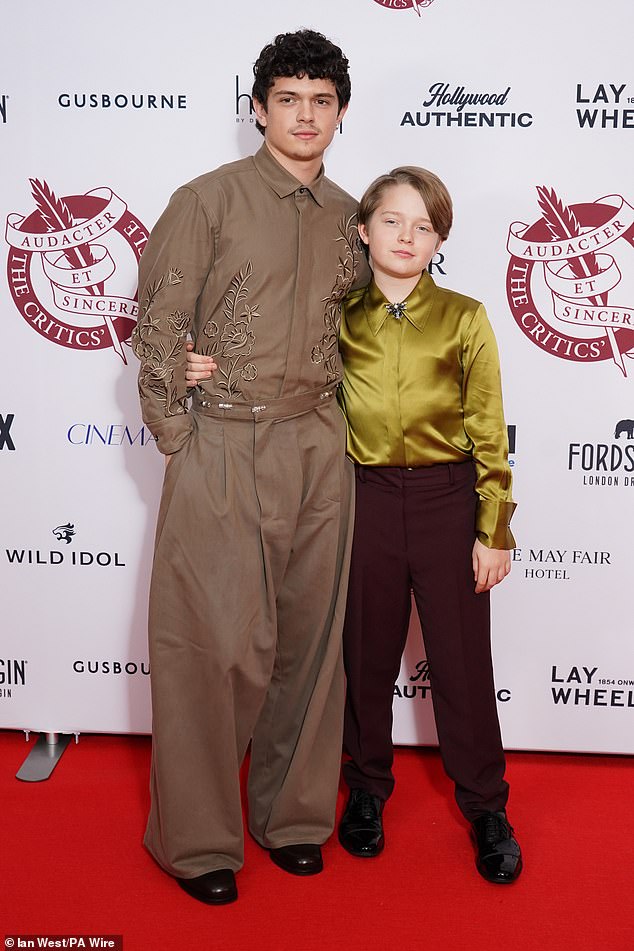 Noah opted for an embroidered brown shirt and matching trousers while Jacobi wore a mustard coloured satin shirt