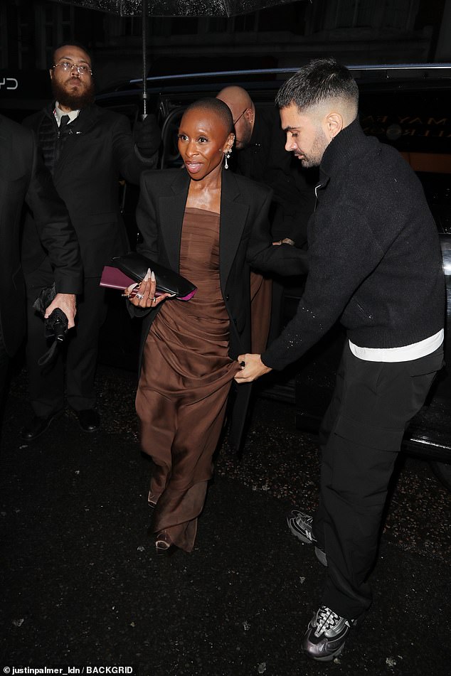 Cynthia covered up with a black blazer jacket as she made her way to the venue