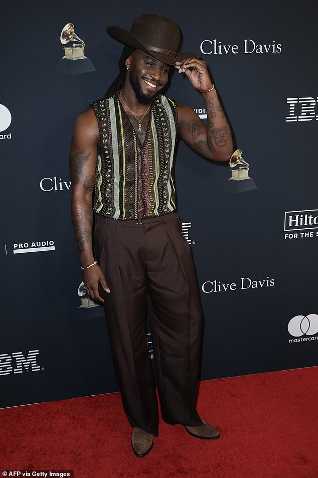 Shaboozey showcased his bold sense of fashion as he rocked a patterned, sequined vest with barrel-style, brown trousers. The country star rocked a wide-brimmed hat and cowboy boots to complete his stylish party outfit