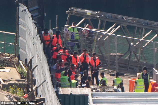 Migrants are brought ashore at Dover in July after being picked up by a Border Force vessel