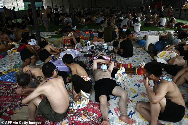 Hundreds of foreigners, pictured above, were sent home from compounds in Myanmar that are run by criminal gangs, with many workers saying they were trafficked and forced to swindle people around the world in protracted internet scams