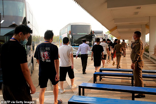 Alleged scam centre workers and victims from China arrive at the border checkpoint with Thailand in Myanmar's eastern Myawaddy township on February 20, 2025