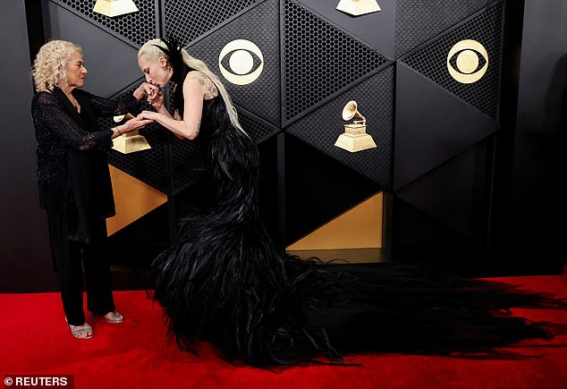 Lady Gaga kisses Carole King's hand