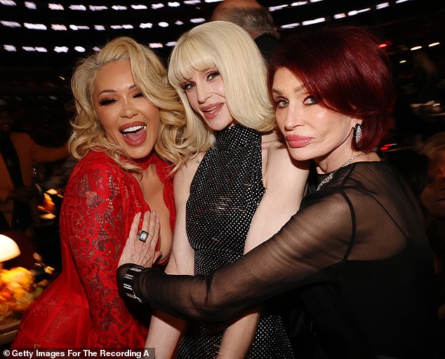 Sharon put her hand on Bunnie Xo's chest as they posed with Kelly