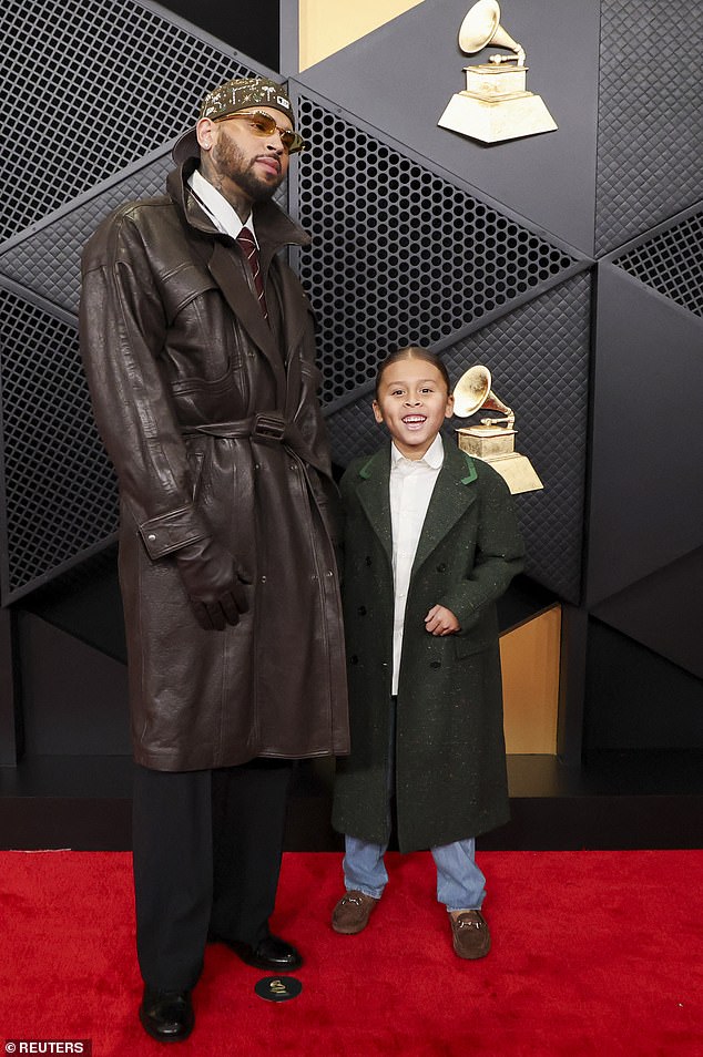 Chris Brown poses at the red carpet with his son
