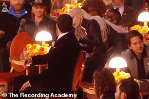 The I Like It crooner seemed to be taken by surprise when she touched him and jumped before he turned around to see who it was