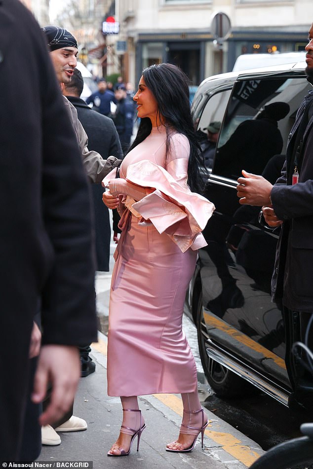 The television personality, 45, beamed as she arrived in the French capital to promote her NikeSKIMS collaboration