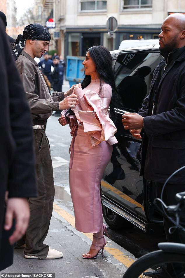 The television personality, 45, beamed as she arrived in the French capital to promote her NikeSKIMS collaboration