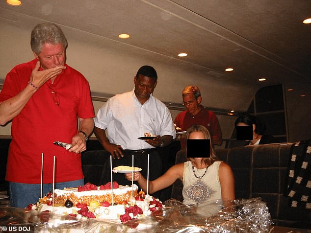 Clinton is seen indulging in some cake having cut a piece using the knife