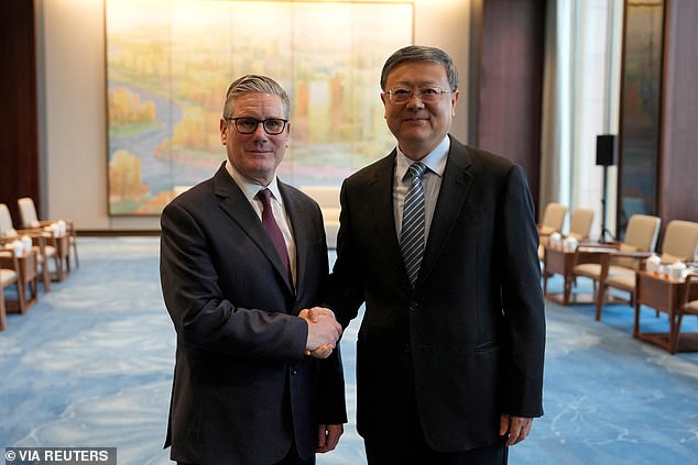 The Prime Minister pictured with Shanghai Party Secretary Chen Jining on Saturday. The Tory leader laughed as she said his recent visit to China 'looked like a dream come true' for a man who was 'virtually a Communist all his life'