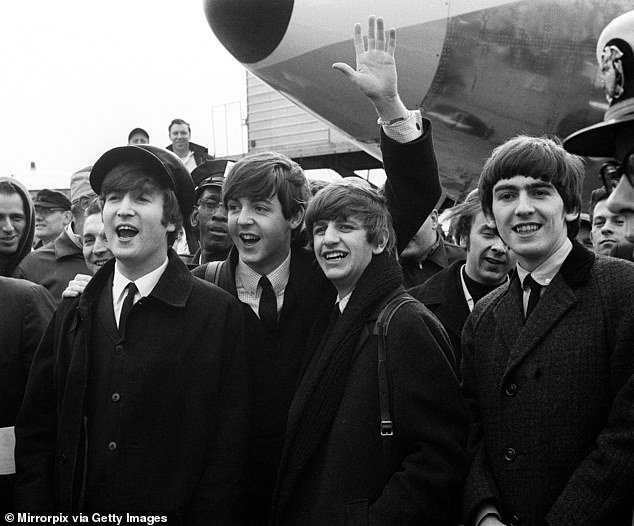 (L-R) John Lennon, Paul McCartney, Ringo Starr and George Harrison are mobbed during their first visit to New York City as a band in February 1964
