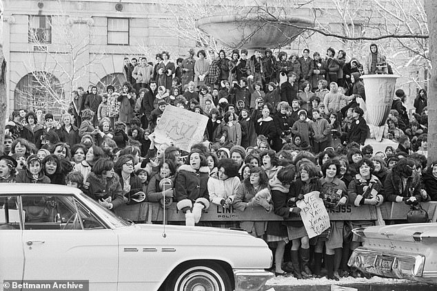 Pictured: A crowd eagerly awaits the arrival of the Beatles outside the Plaza Hotel in 1964