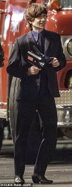 Dressed in character as the drummer, Keoghan was seen filming the staged chaos with a vintage video camera