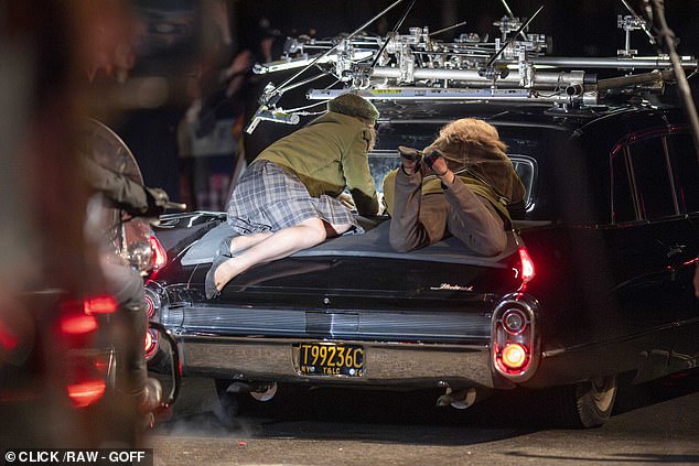 Extras portraying hysterical female fans were filmed throwing themselves at the band's car
