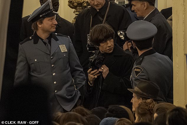 Keoghan was seen clutching his camera while surrounded by extras dressed as Newn York City police officers