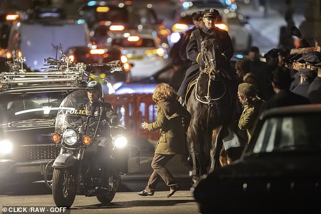 The group were flanked by police officers on horseback and motorcycle in scenes filmed on Sunday evening