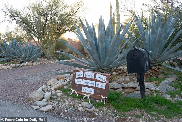 Outside Nancy's Arizona home, where neighbors left a sign saying they 'stand with' the 84-year-old and her family