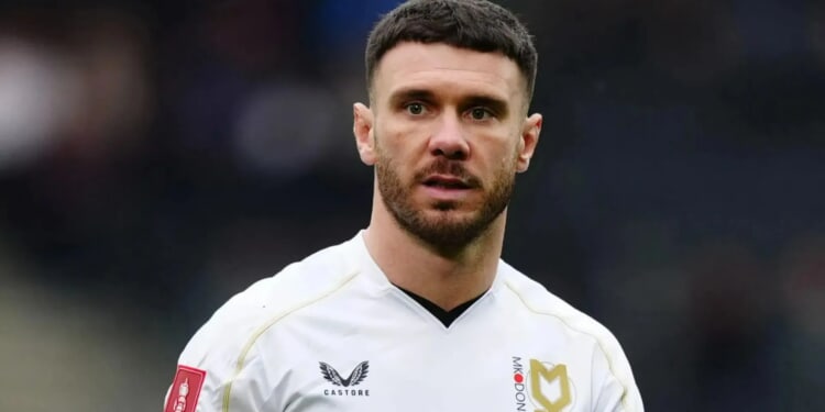 Footballer chased off three burglars after being woken by torch