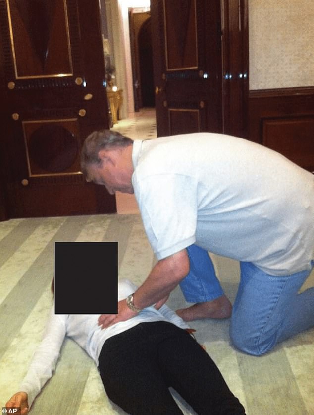 In an extraordinary set of pictures, Andrew is seen looking directly at the camera as he kneels on all fours above a woman whose face is redacted