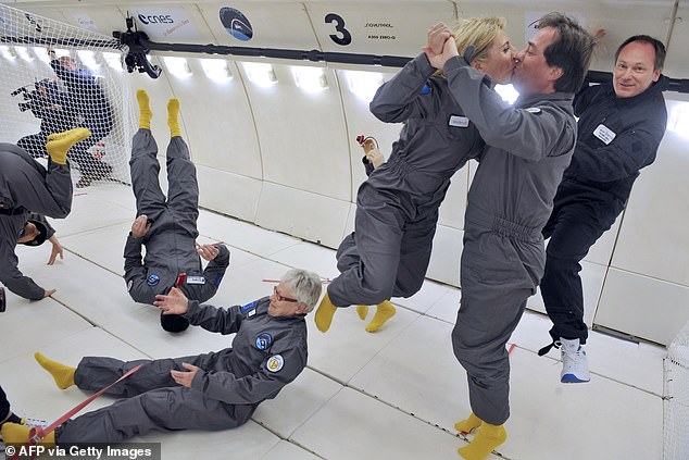 Passengers kiss aboard a flight that simulates the weightlessness of space. Zero-gravity intimacy is just one of the challenges facing extraterrestrial reproduction