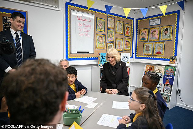 The King's wife meets pupil librarians as she attends the opening of the library in Camden