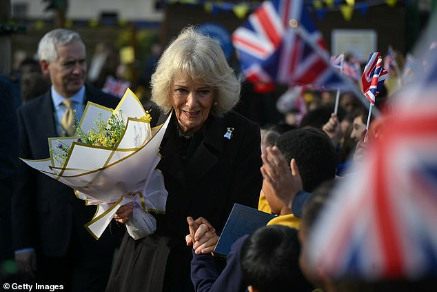 Queen Camilla departs after attending the opening of a library at Christ Church Primary School