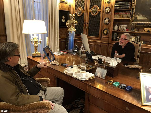 An undated photograph shows Jeffrey Epstein talking with Steve Bannon