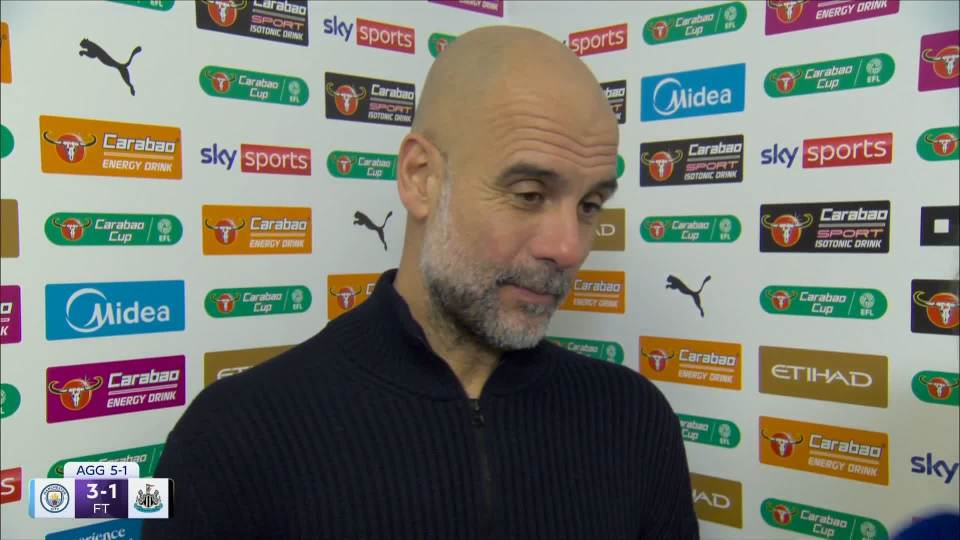 Pep Guardiola standing in front of a sponsor board after a football match.