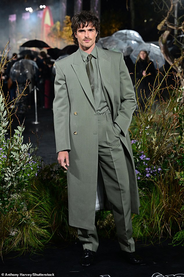 Joining his co-star for the premiere, Jacob opted for a dapper dark green suit as he posed for snaps