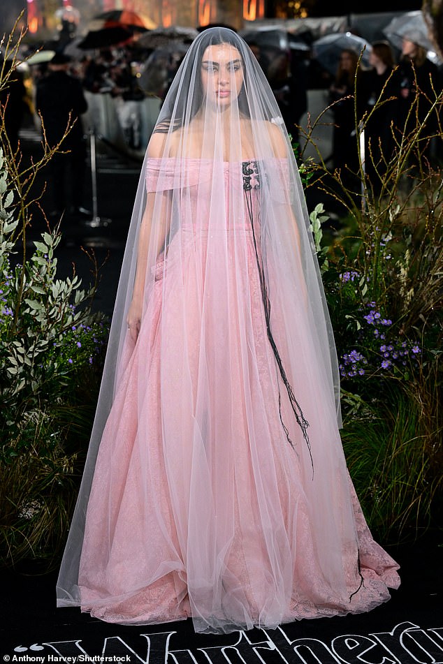 Charli XCX stunned in a pink bridal-esque Erdem gown and veil as she made an early arrival for the star-studded premiere