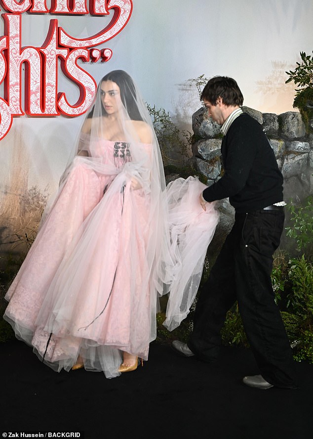 Her dress boasted a voluminous skirt that needed a helping hand as Charli made her way along the black carpet