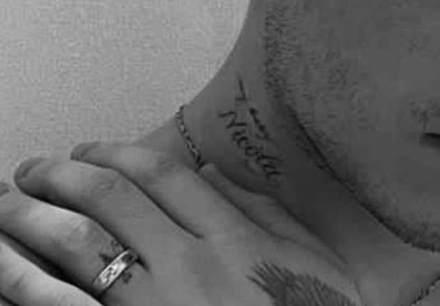 Brooklyn has Nicola's name written alongside the words 'My baby' on his neck