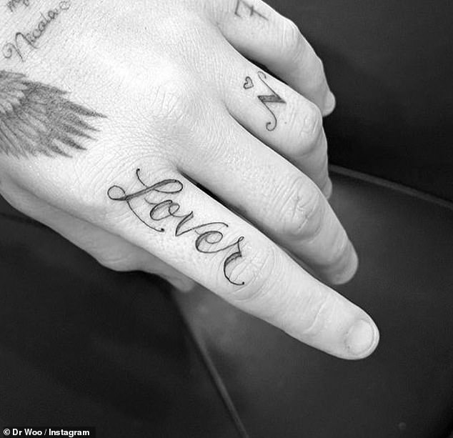 He also opted to ink 'lover' across his index finger