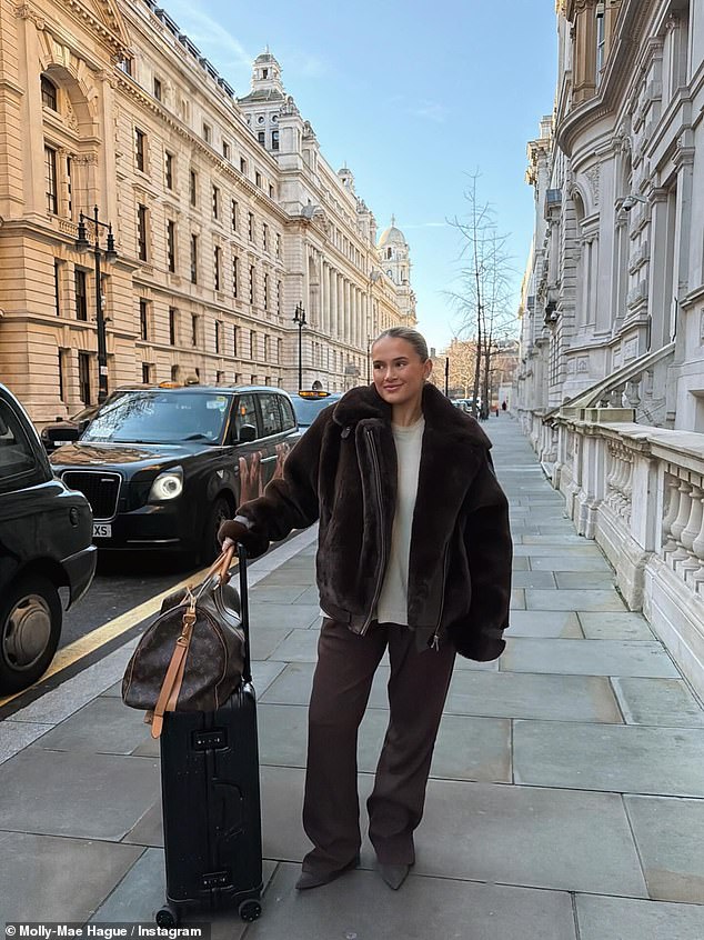 In another post, she wore a cream jumper with a fur coat and wide fit trousers during a work trip to London